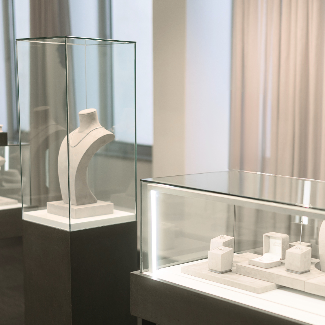 Display case in Affinity Diamonds Brisbane Boutique with a white sculpture inside, set against a neutral background.